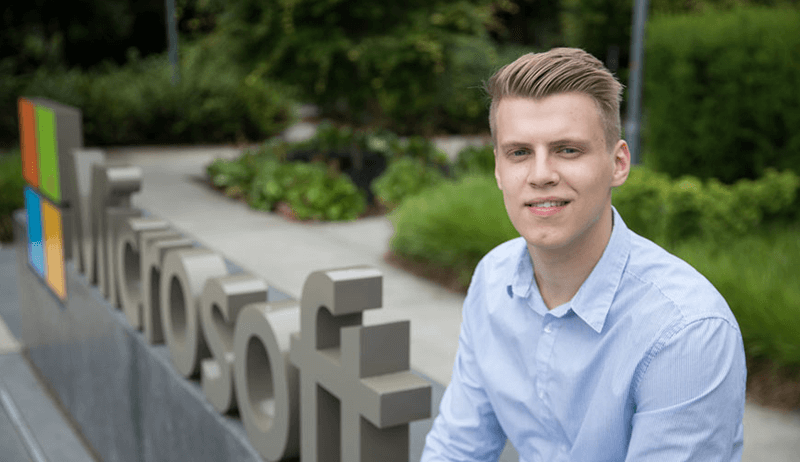 SBGE Alumnus Ben sits in front of Microsoft headquarters